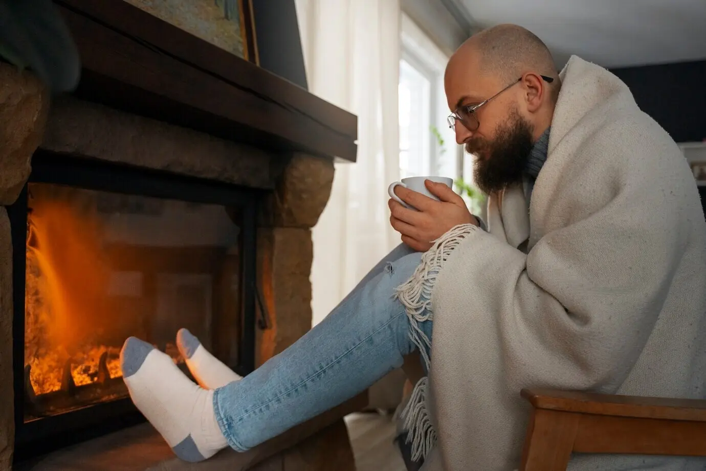 Man warming himself by a fireplace amid an energy crisis