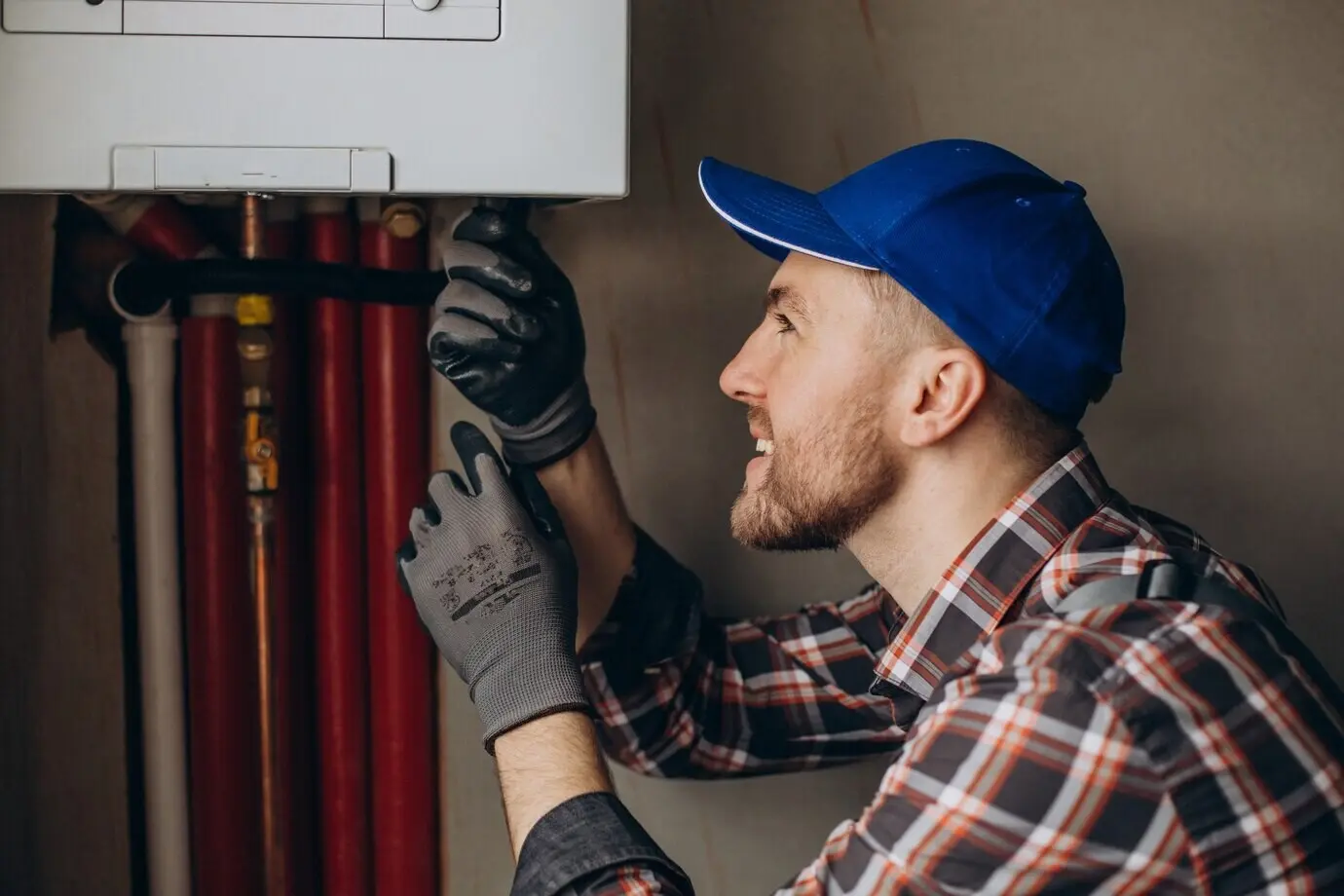 A serviceman adjusting a house’s heating system.